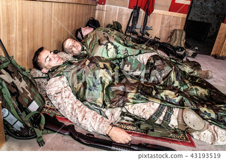 Tired soldiers sleeping on floor at temporary base 43193519