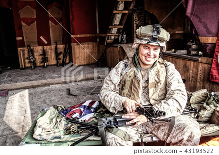 Marine cleaning machine gun barrel during rest Marine cleaning machine gun barrel during rest 43193522