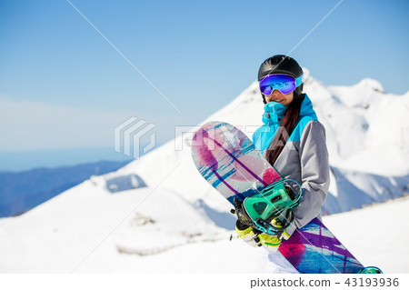 Photo of woman hiking helmet with snowboard on snow mountains background Photo of woman hiking helmet with snowboard on snow mountains background 43193936