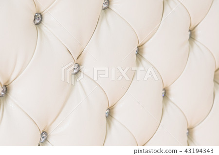 Beige soft tapestry pattern background with symmetrical buttons on the corners of diamonds. Soft and 43194343