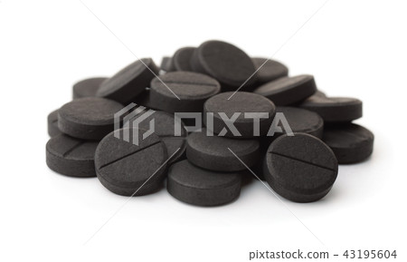 Pile of activated charcoal pills Pile of activated charcoal pills 43195604