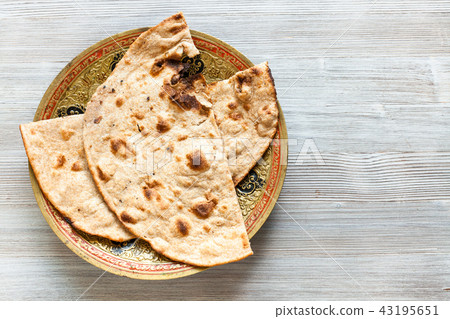 Tandoori Roti whole wheat flat bread on gray table Tandoori Roti whole wheat flat bread on gray table 43195651