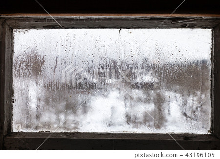 water drops on misted frozen window of rural house 43196105