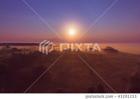 Landscape at sunrise with sunshine in the fog Landscape at sunrise with sunshine in the fog 43201153