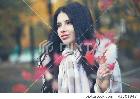 Beautiful brunette woman in autumn park outdoors 43201948