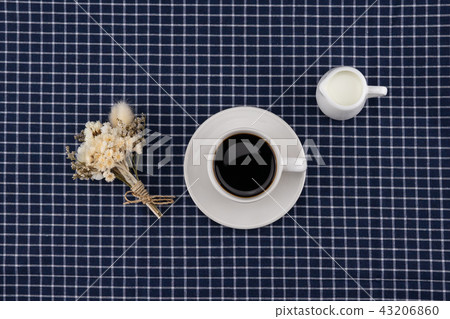 A cup of coffee, milk and white flower bouquet A cup of coffee, milk and white flower bouquet 43206860