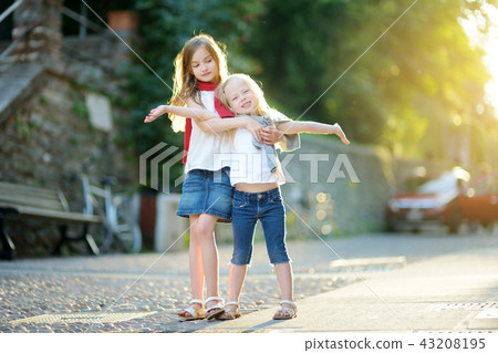 Two adorable little sisters having fun together 43208195
