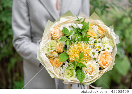 Beautiful spring bouquet. Arrangement with mix flowers. The concept of a flower shop, a small family Beautiful spring bouquet. Arrangement with mix flowers. The concept of a flower shop, a small family 43208409