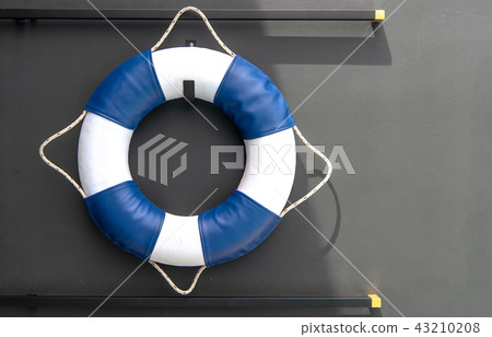 White and blue lifebuoy on grey background. White and blue lifebuoy on grey background. 43210208