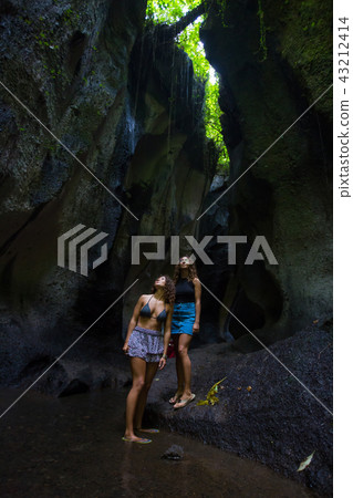 Tourist in cave. Friends exploring nature caves Tourist in cave. Friends exploring nature caves 43212414