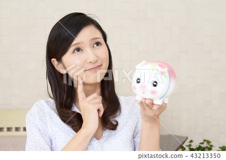 A woman with pig's piggy bank A woman with pig's piggy bank 43213350