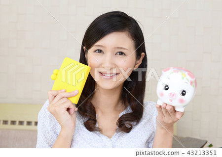 A woman with pig's piggy bank A woman with pig's piggy bank 43213351