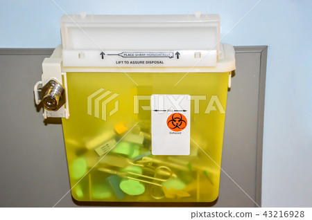 Photo of a locked yellow sharps container with use Photo of a locked yellow sharps container with use 43216928