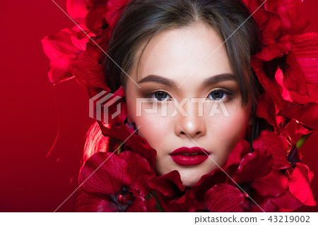 Asian tanned skin woman with strong color red lips 43219002