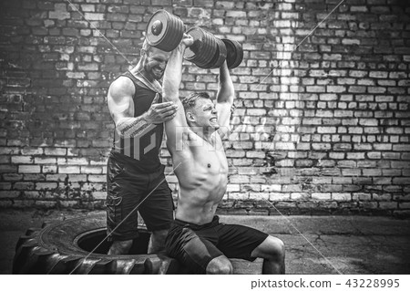 Two muscular athletes training Two muscular athletes training 43228995