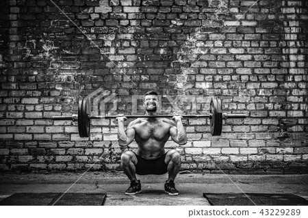 Muscular fitness man doing deadlift a barbell over his head in outdoor, street gym. Functional Muscular fitness man doing deadlift a barbell over his head in outdoor, street gym. Functional 43229289