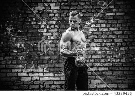 Athletic man working out with a kettlebell. Strength and motivation 43229436