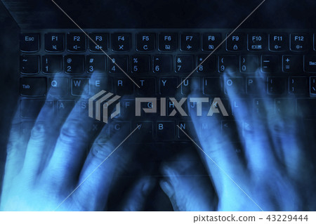 hands are typing on the keyboard in the dark. The concept of hacking, haters, fake and trolling hands are typing on the keyboard in the dark. The concept of hacking, haters, fake and trolling 43229444