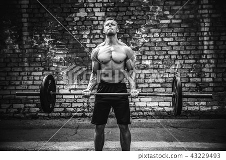 Muscular fitness man doing deadlift a barbell over his head in outdoor, street gym. Functional Muscular fitness man doing deadlift a barbell over his head in outdoor, street gym. Functional 43229493