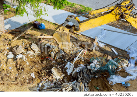 Backhoe working on garbage dump in soil pollution Backhoe working on garbage dump in soil pollution 43230203