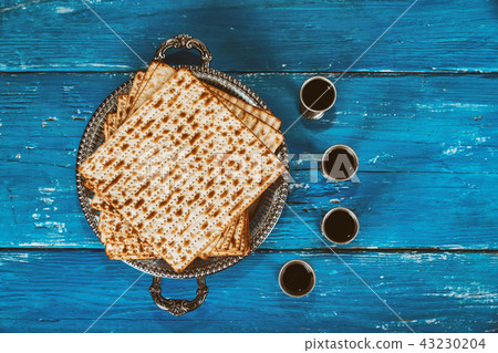 A Jewish Matzah bread with four glasses wine 43230204