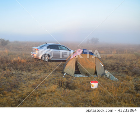 Car next to the tent. Fog at dawn Car next to the tent. Fog at dawn 43232864