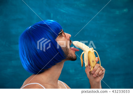 Young male cross dressing person wearing blue wig Young male cross dressing person wearing blue wig 43233033