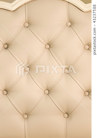 Beige soft tapestry pattern background with symmetrical buttons on the corners of diamonds. Soft and 43237588