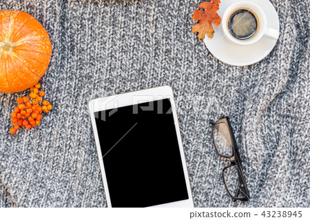 Home workplace with coffee cup on knitted plaid 43238945
