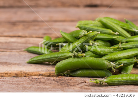 Pile of green fresh peas on the table. Pile of green fresh peas on the table. 43239109