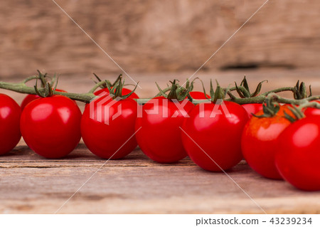 Bunch of shiny cherry tomatoes, close up. 43239234