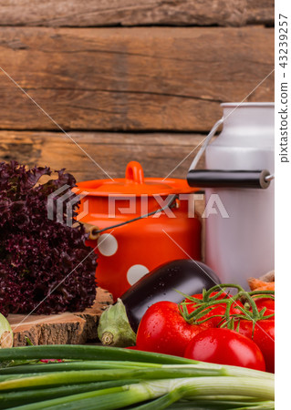 Vegetables mix and milk cans. 43239257