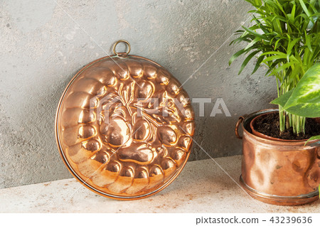Vintage copper mold on a concrete background. Vintage copper mold on a concrete background. 43239636