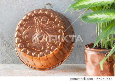 Vintage copper mold on a concrete background. Vintage copper mold on a concrete background. 43239638