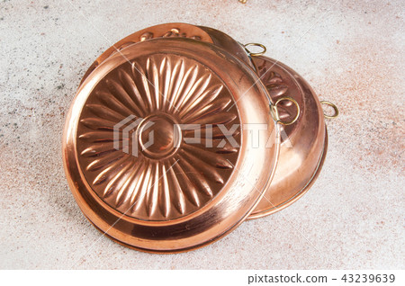 Vintage copper molds on a concrete background. Vintage copper molds on a concrete background. 43239639
