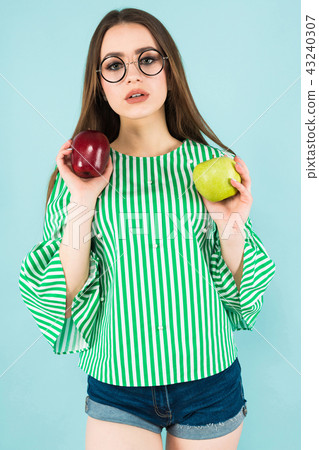 Young woman with two apples Young woman with two apples 43240307