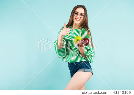 Young woman with two apples Young woman with two apples 43240309