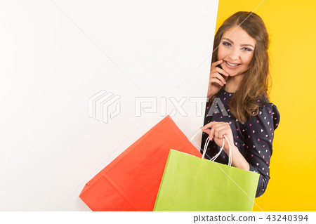Attractive woman with banner and shopping bags Attractive woman with banner and shopping bags 43240394