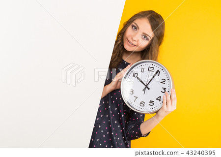 Brunette woman with clocks and blank banner Brunette woman with clocks and blank banner 43240395