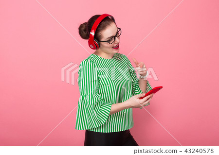 Businesswoman with phone and earphones 43240578