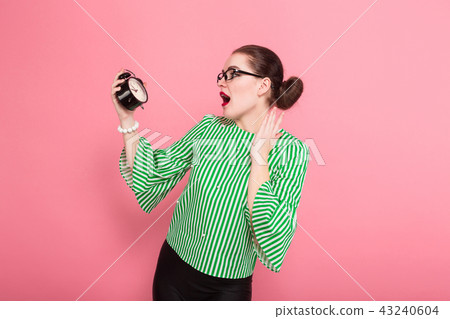 Businesswoman with hair bun and clocks 43240604