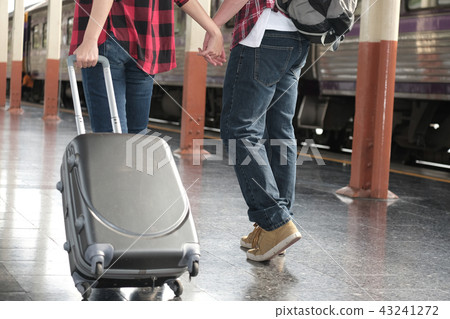 man & woman with backpack & baggage waiting for train at railway station. loving couple traveler travel together on holiday 43241272