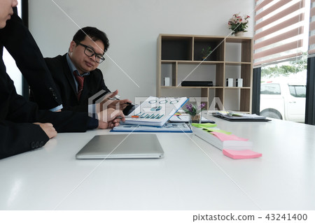 business adviser analyzing company financial report. professional investor discussing idea. businessman working on startup project with co working team. 43241400