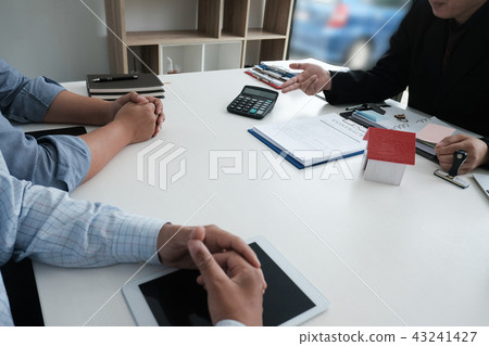 real estate agent have meeting with customer. sale & purchase property with house model signing contract document. realtor talk with client. real estate agent have meeting with customer. sale & purchase property with house model signing contract document. realtor talk with client. 43241427