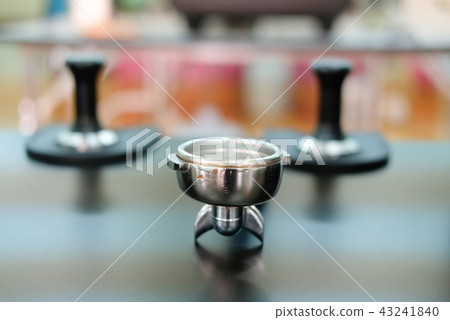 portafilter & tamper on counter bar at cafe. espresso tamping for coffee machine 43241840