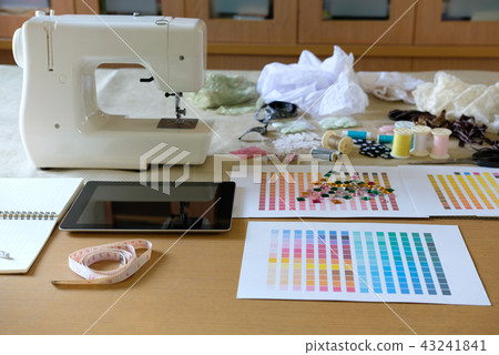 equipment on fashion designer desk in studio. design thing in atelier equipment on fashion designer desk in studio. design thing in atelier 43241841