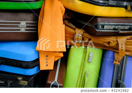 pile of luggage and baggage. old style suitcase & clothes. travel & journey concept pile of luggage and baggage. old style suitcase & clothes. travel & journey concept 43241982