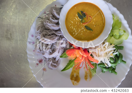 Thai vermicelli with natural herbal color. rice noodle, vegetable & curry soup Thai vermicelli with natural herbal color. rice noodle, vegetable & curry soup 43242083