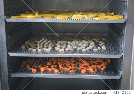 tropical fruit drying in hot oven. dried mango, carrot, longan on stainless tray 43242162