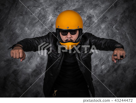 biker man in motorcycle helmet and leather jacket biker man in motorcycle helmet and leather jacket 43244472